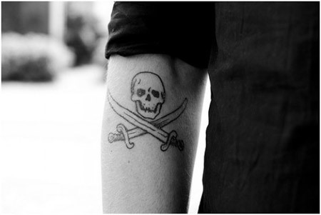 Black Outline Pirate Skull With Two Crossing Swords Tattoo On Left Arm