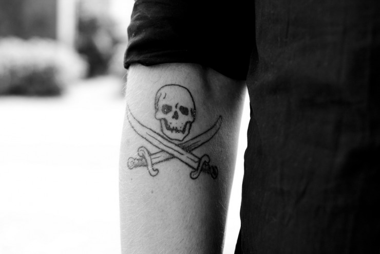 Black Outline Pirate Symbol Tattoo On Left Half Sleeve