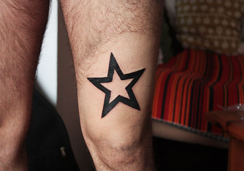 Black Outline Star Tattoo On Left Thigh