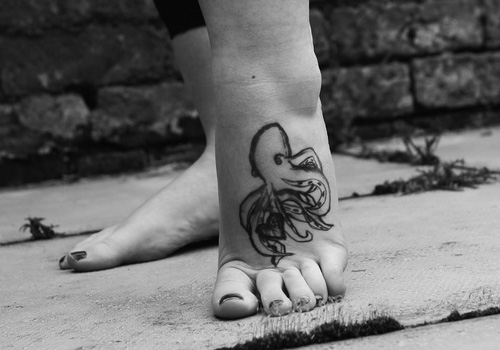 Black Small Octopus Tattoo On Girl Left Foot