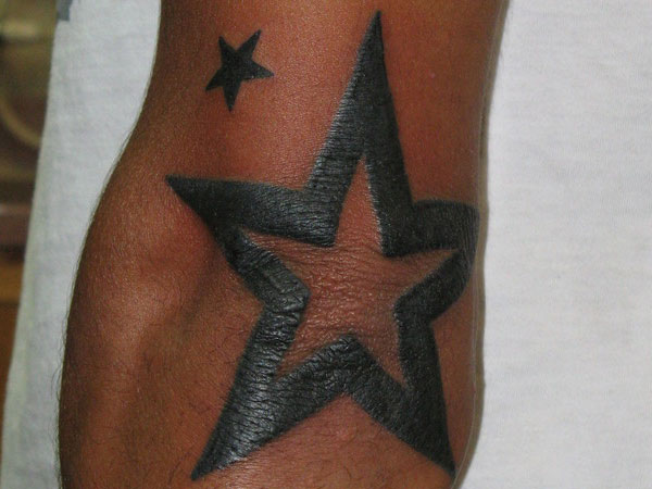 Black Star Tattoo On Elbow