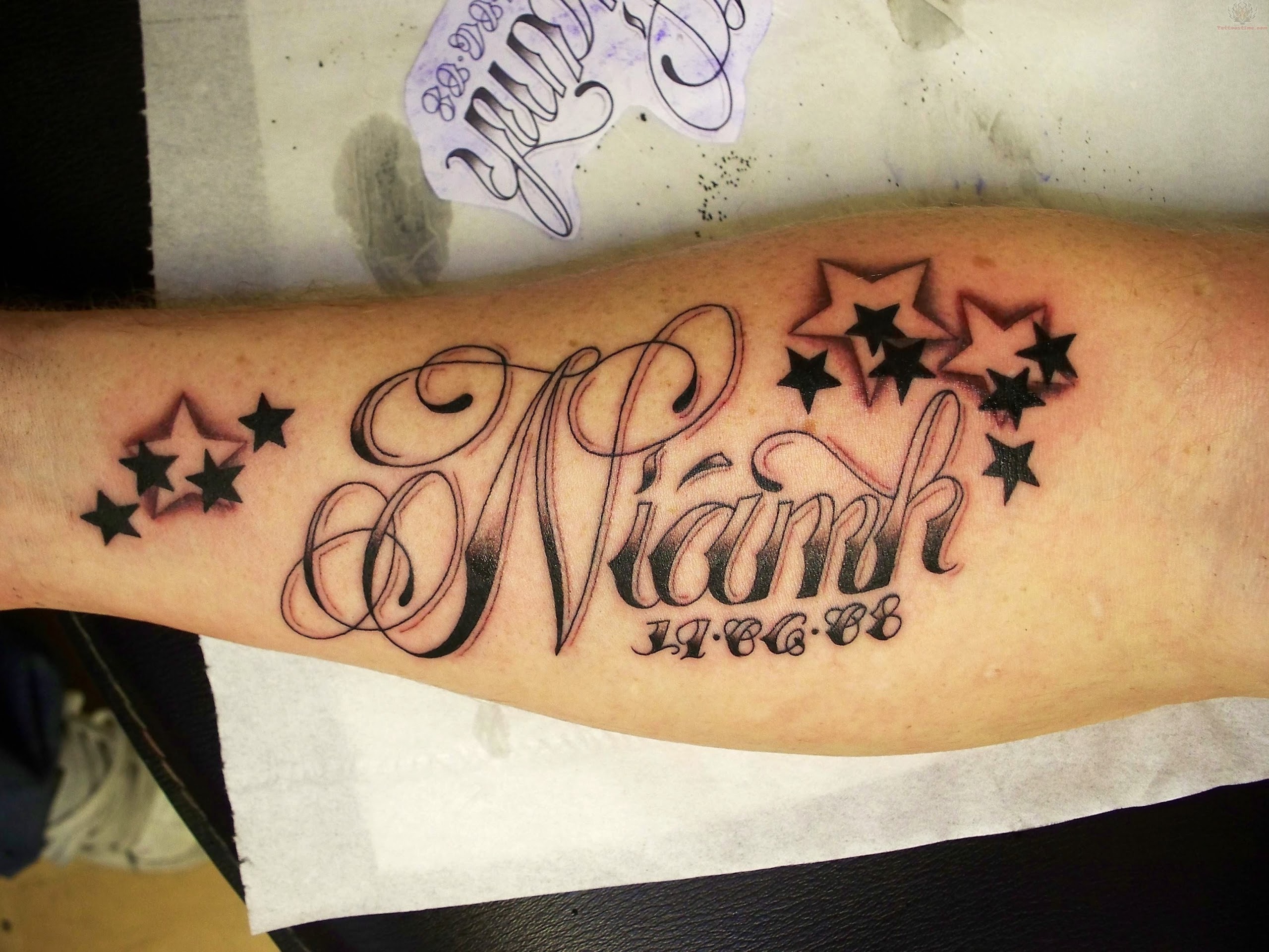 Black Stars And Memorial Star Tattoos On Forearm