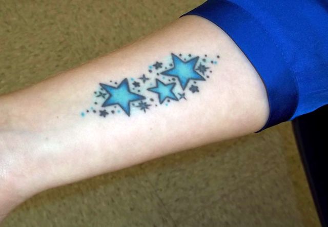 Blue Ink Star Tattoos On Forearm