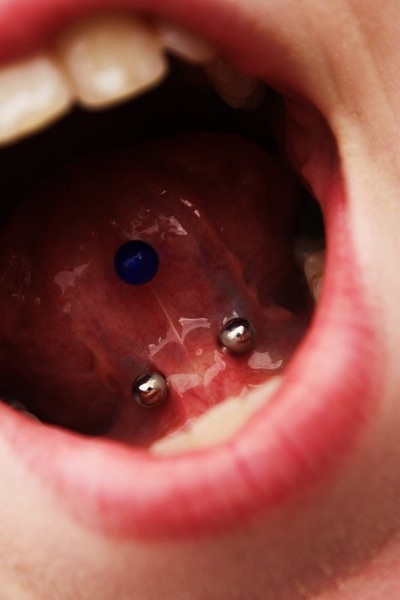 Blue Stud Tongue Piercing And Webbing Piercing With Silver Barbell