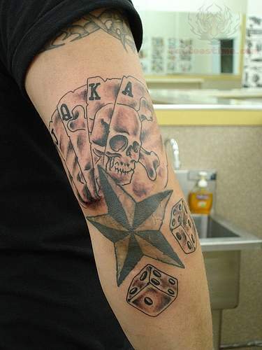 Cards, Dice And Nautical Star Tattoo On Elbow