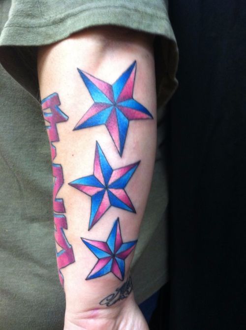 Colored Nautical Star Tattoos On Left Arm