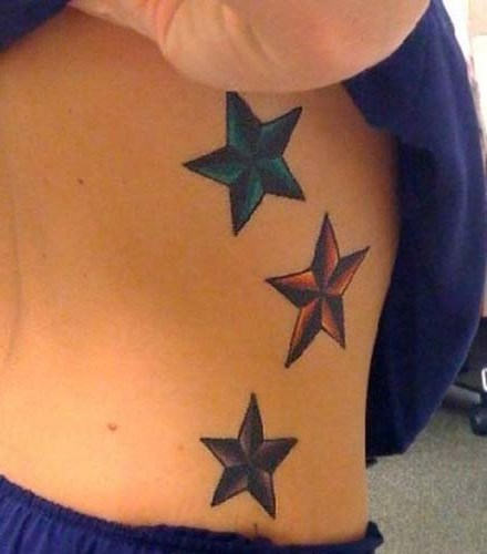 Colored Nautical Stars Tattoos On Side Rib