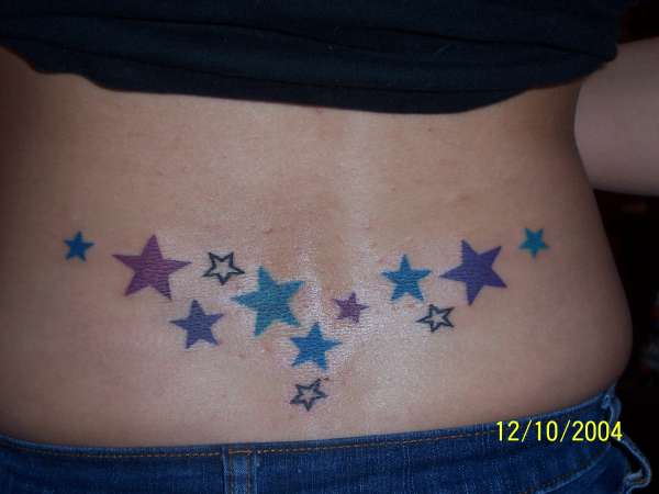 Colored Star Tattoo On Girl Lower Back