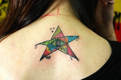 Colored Star Tattoo On Girl Upper Back