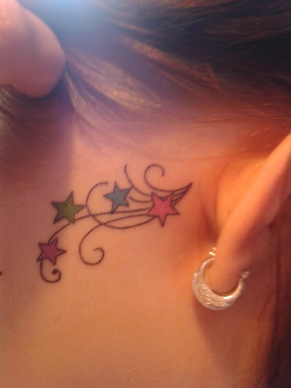 Colored Star Tattoos Behind Ear For Young Girls