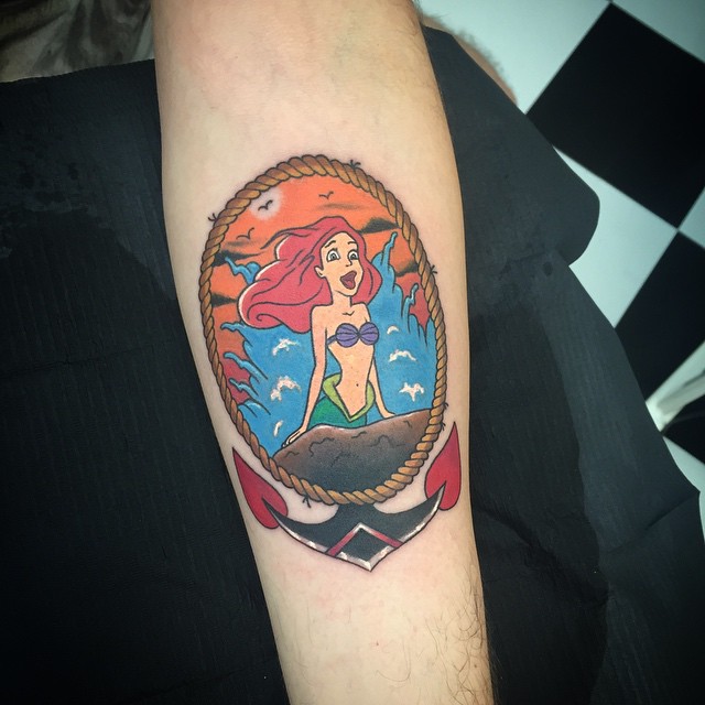 Colorful Cartoon Mermaid In Anchor Frame Tattoo Design For Forearm