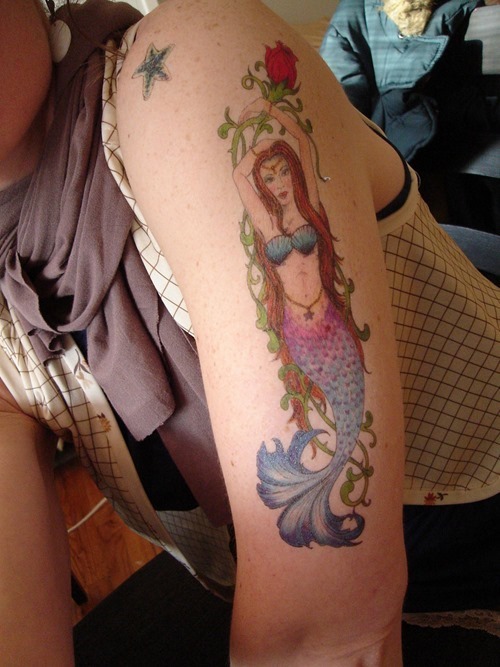 Colorful Mermaid With Rose Tattoo On Man Left Half Sleeve