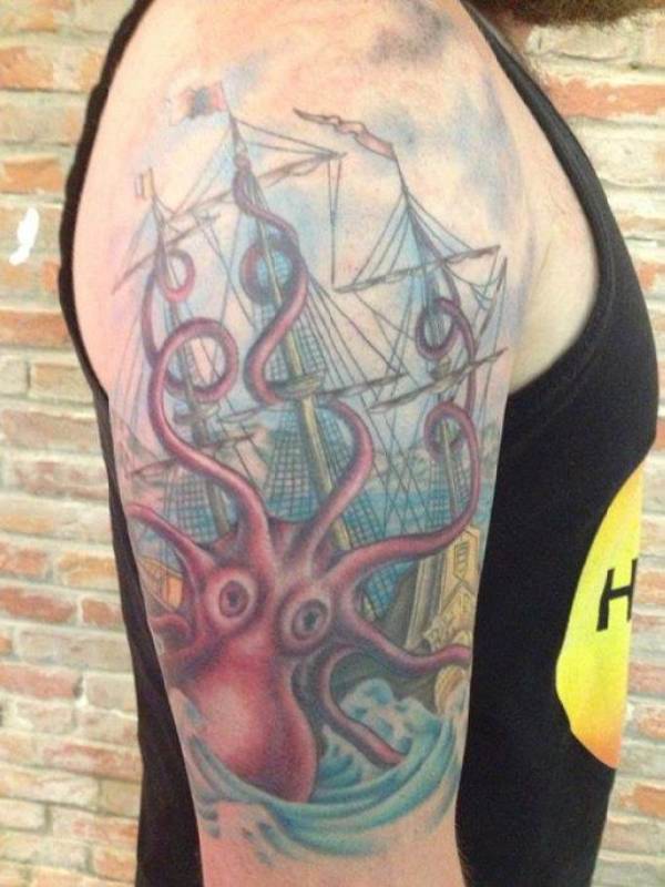 Colorful Octopus With Ship Tattoo On Man Right Half Sleeve