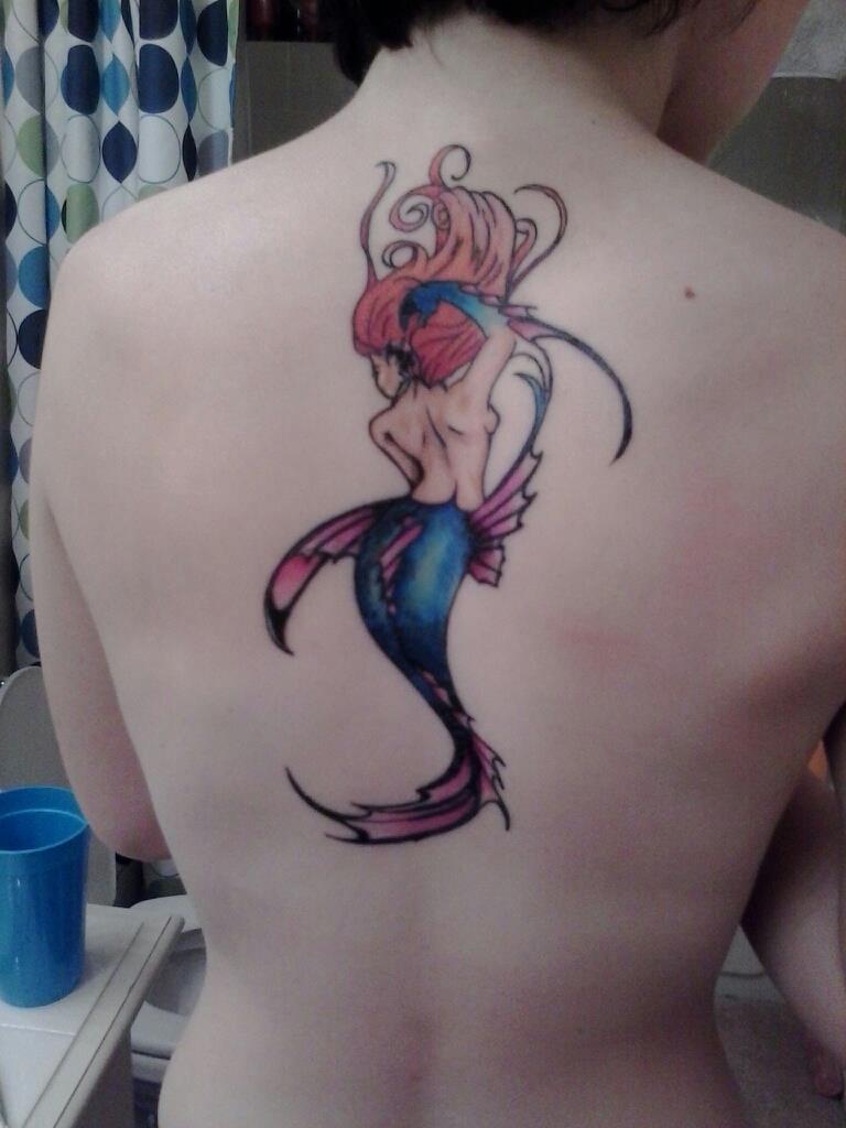 Colorful Swimming Mermaid Tattoo On Upper Back