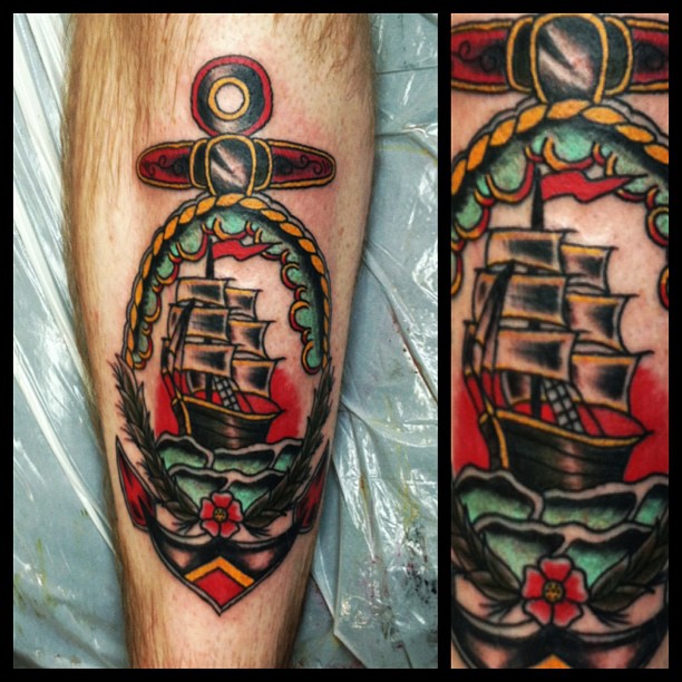 Colorful Traditional Ship In Anchor Frame Tattoo Design For Leg