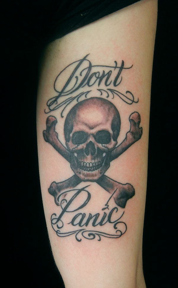 Don't Panic - Black Ink Pirate Skull With Crossbone Tattoo Design For Bicep