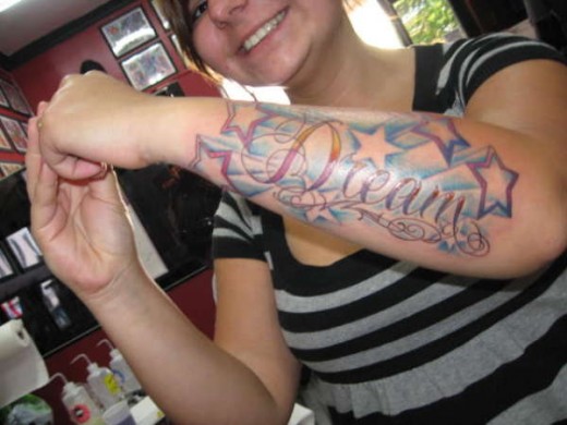 Girl Showing Her Dream Star Tattoos On Forearm