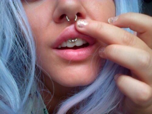 Girl Showing Her Septum And Smiley Piercing