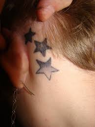 Girl Showing Her Star Tattoos Behind Ear