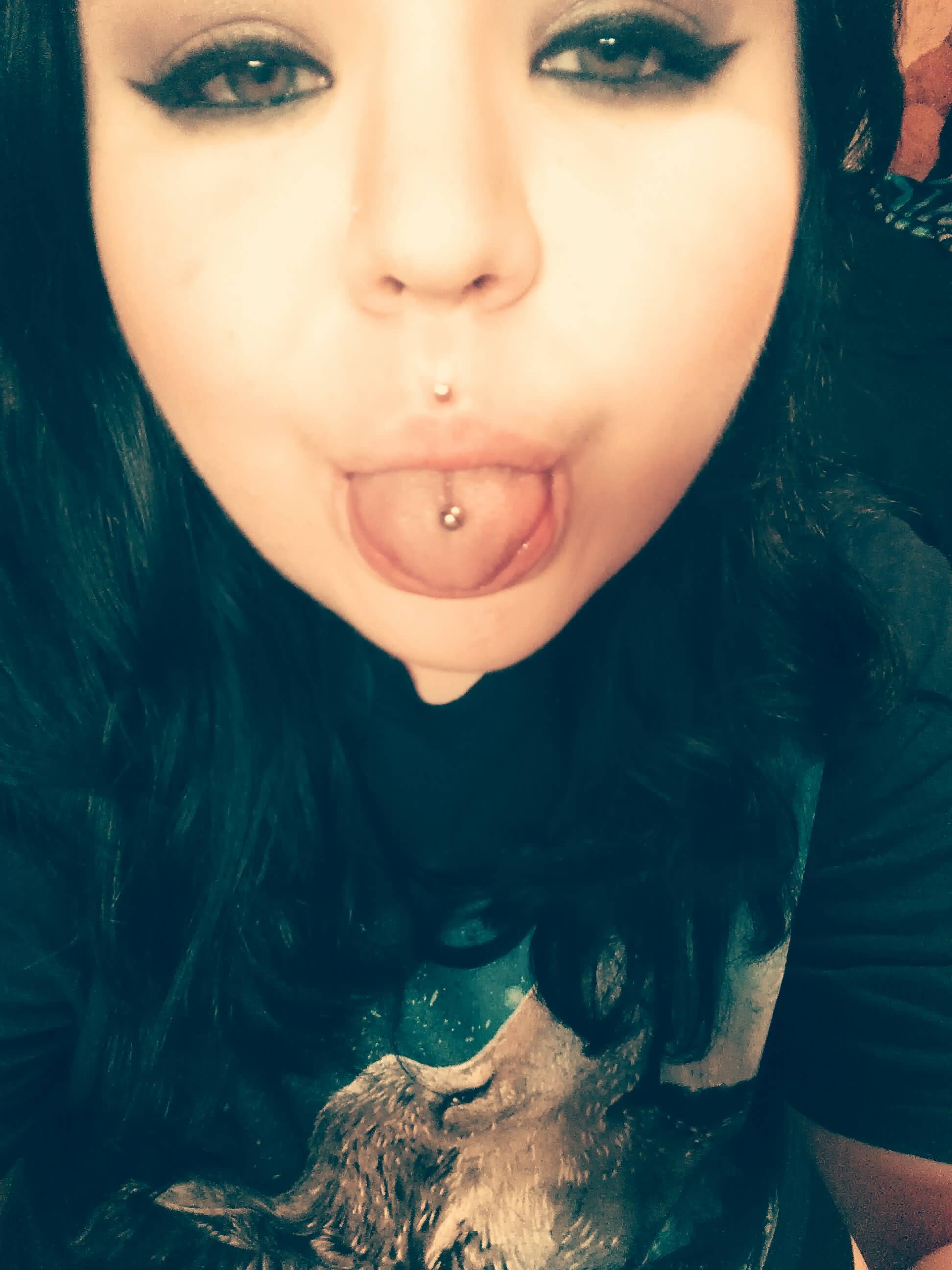 Girl Showing Her Tongue Piercing And Medusa Piercing