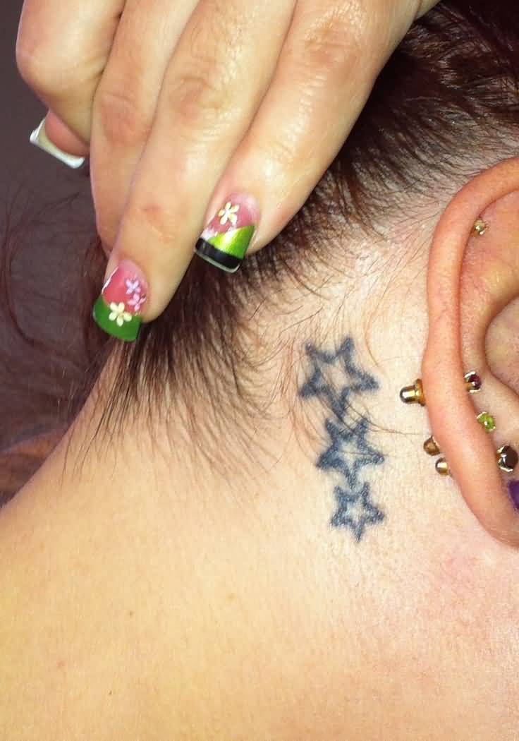 Girl Showing Three Small Stars Tattoo Behind The Ear
