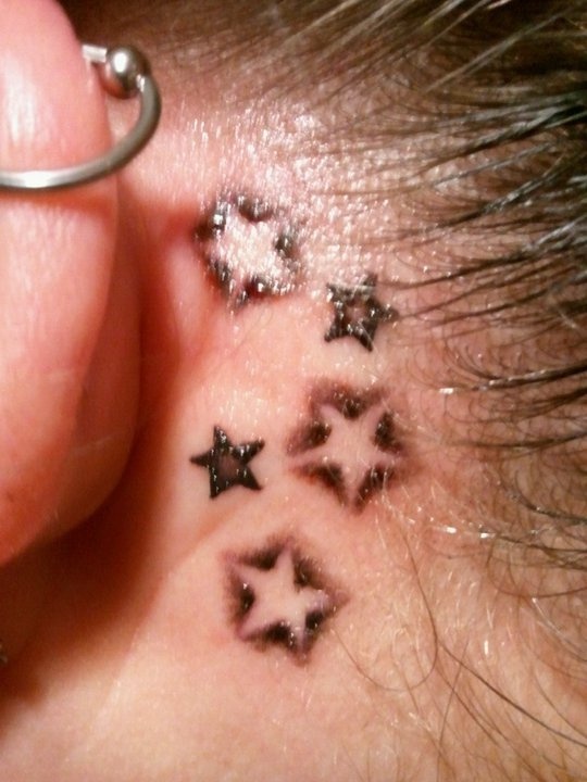 Grey And Black Star Tattoos Behind The Ear