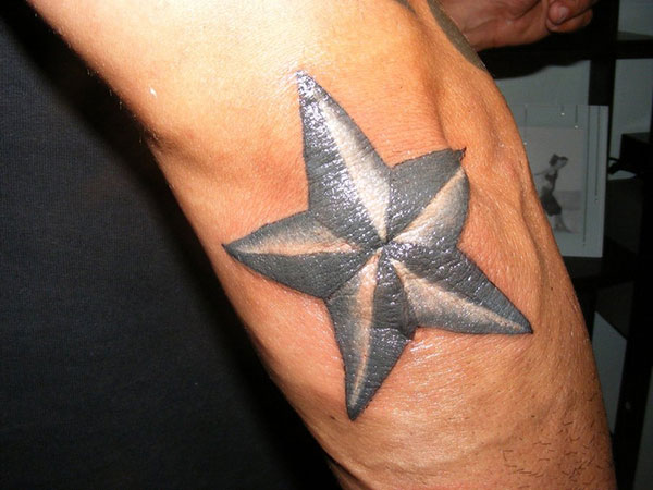 Grey And White Nautical Star Tattoo On Elbow