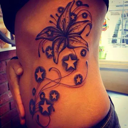 Lily Flower And Star Tattoos On Side Rib