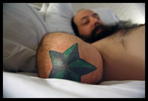 Man With Green Elbow Star Tattoo