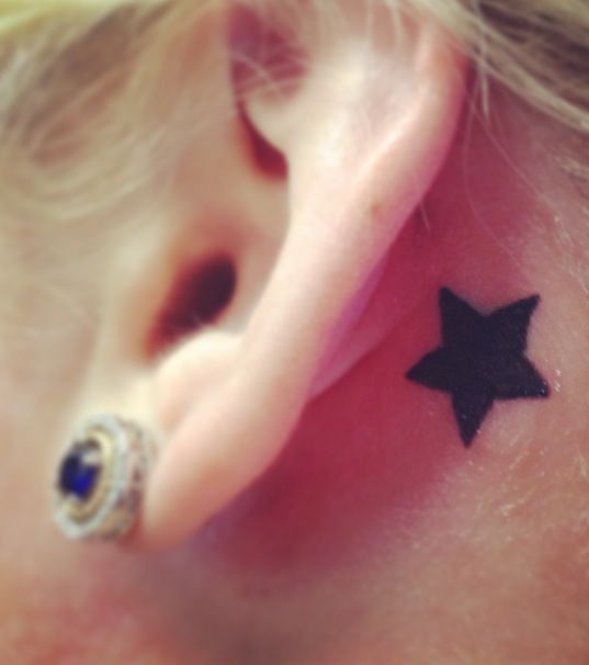 Nice Black Silhouette Star Tattoo Behind Ear