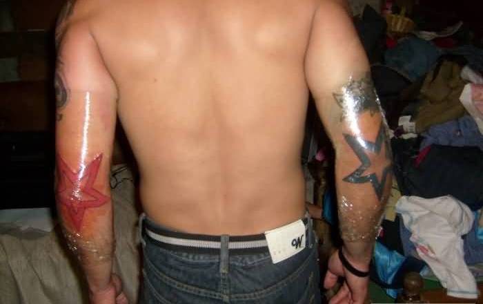 Red And Black Star Tattoos On Elbow For Men
