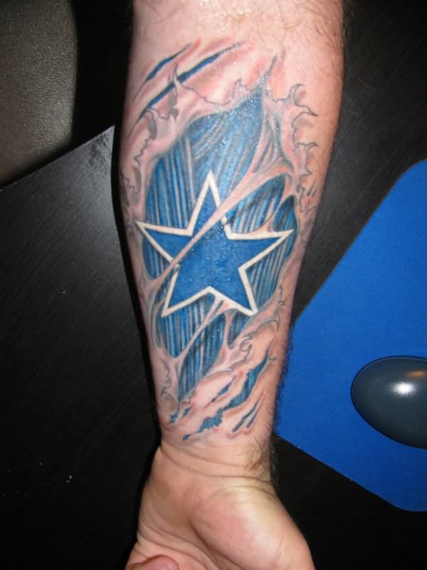 Ripped Skin Blue Ink Star Tattoo On Forearm