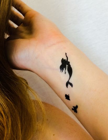 Silhouette Small Mermaid Tattoo On Girl Left Wrist