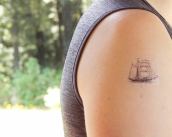 Simple Little Pirate Ship Tattoo On Right Shoulder