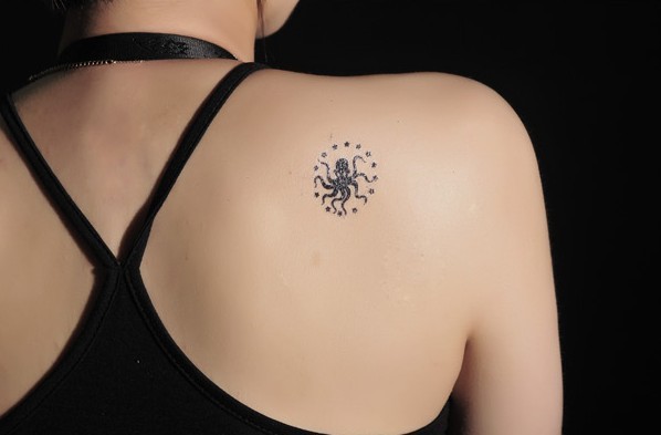 Small Black Ink Octopus Tattoo On Women Right Back Shoulder
