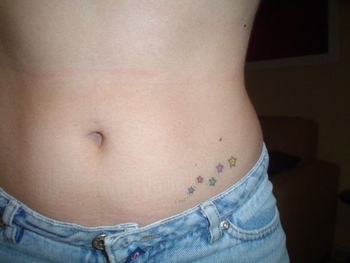 Small Colored Stars Tattoos On Hip