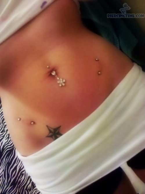 Surface Hips Piercing And Nautical Star Tattoos