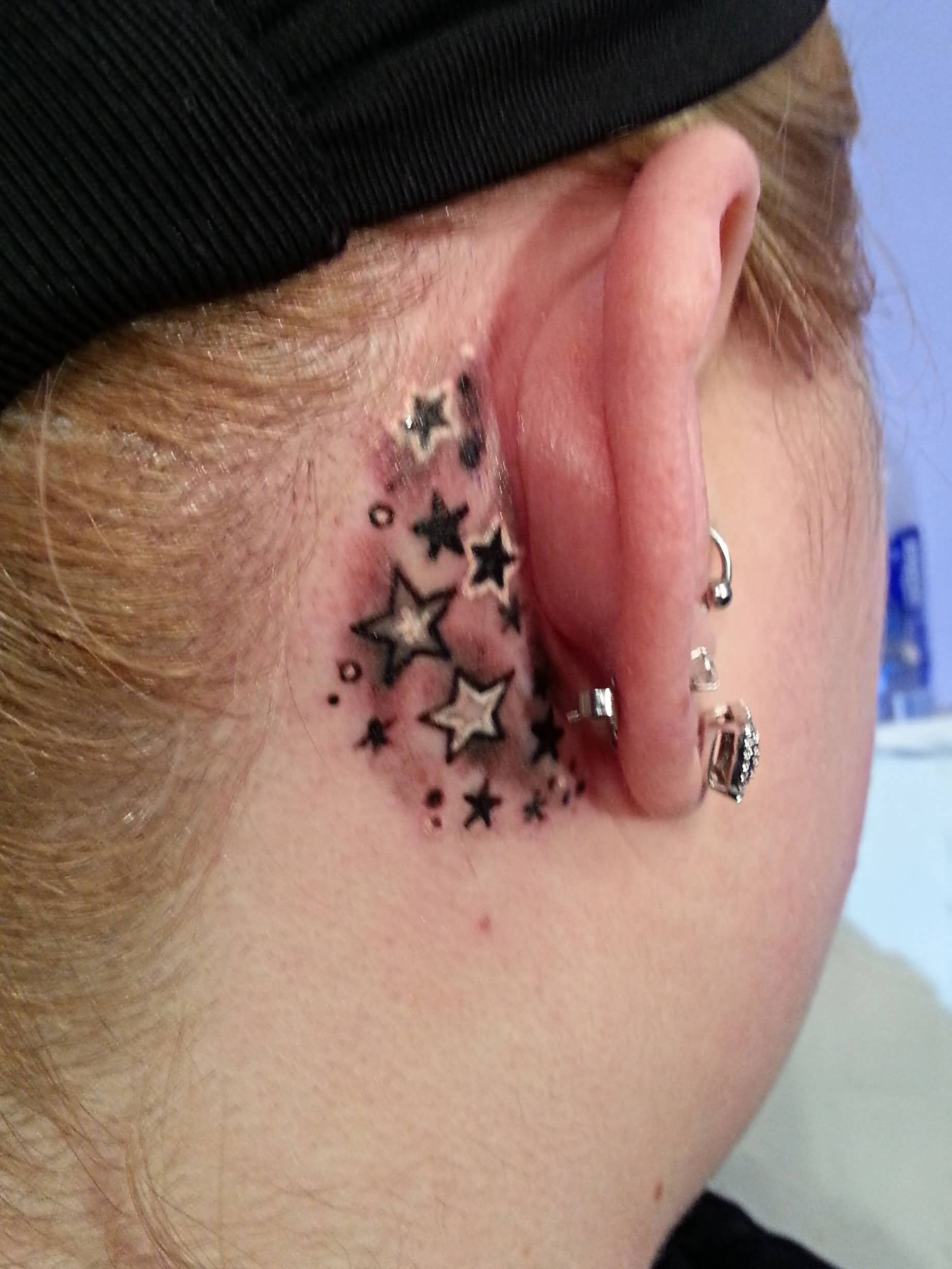 White And Black Ink Star Tattoos Behind Ear