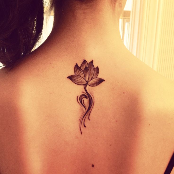 Simple Black Ink Lotus Flower Tattoo On Girl Upper Back