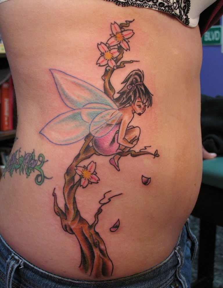 Amazing Colorful Fairy On Branch Tattoo On Women Right Side Rib