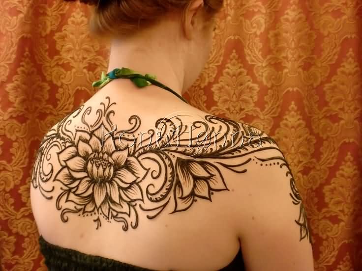 Attractive Black Ink Henna Lotus Tattoo On Girl Upper Back