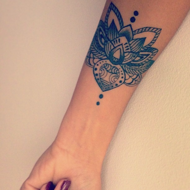 Attractive Black Ink Lotus Flower Tattoo On Girl Right Wrist