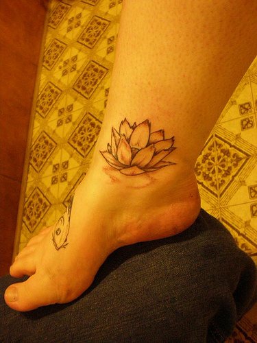 Attractive Black Ink Lotus Flower Tattoo On Right Foot Ankle