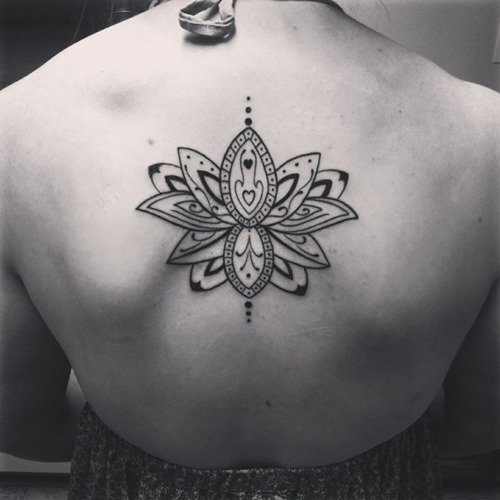 Attractive Black Ink Lotus Tattoo On Female Upper Back