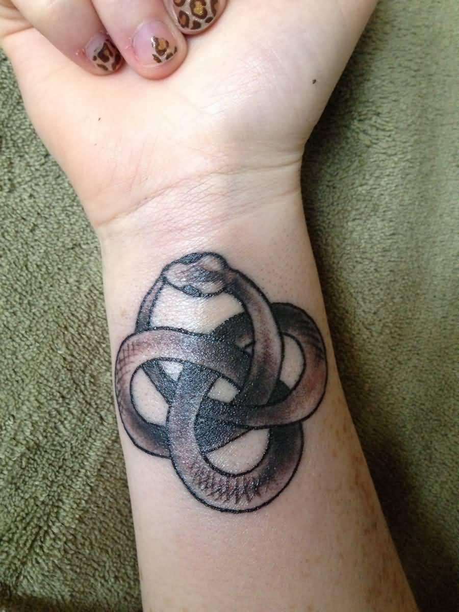 Attractive Black Ink Snake Tattoo On Girl Right Wrist
