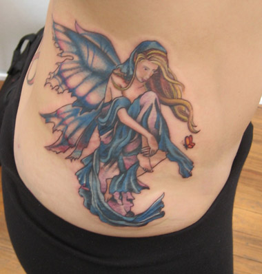 Attractive Fairy With Fairy Dust Tattoo On Right Side Rib