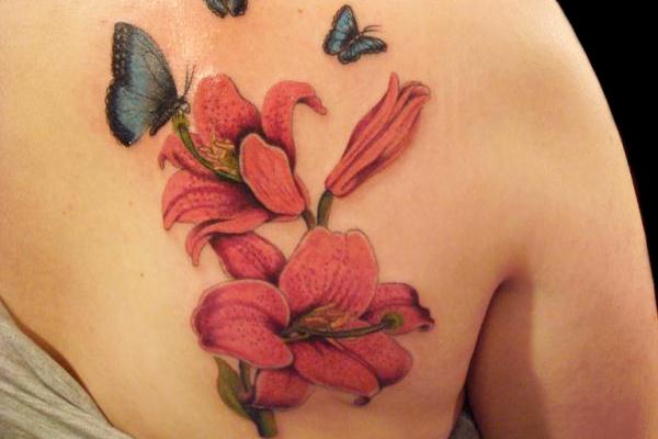 Attractive Lily Flowers With Flying Butterflies Tattoo On Right Back Shoulder