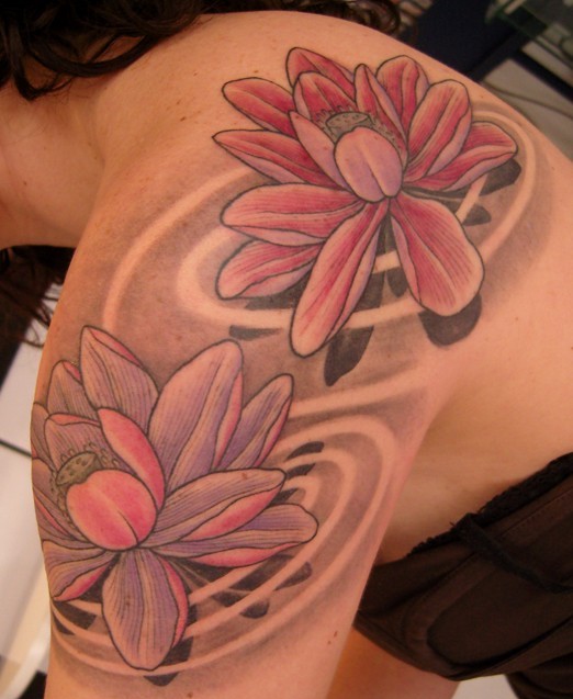 Attractive Lotus Flowers Tattoo On Left Shoulder