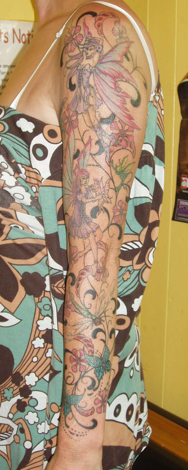 Awesome Colorful Flowers With Flying Fairies And Butterflies Tattoo On Women Left Full Sleeve