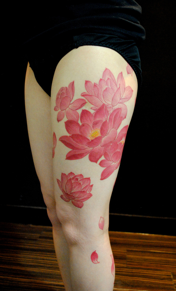 Awesome Pink Ink Lotus Flowers Tattoo On Girl Left Thigh